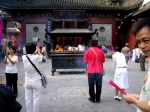 Chinese Tourists burn incense at the Old Town Temple - Shanghai, China